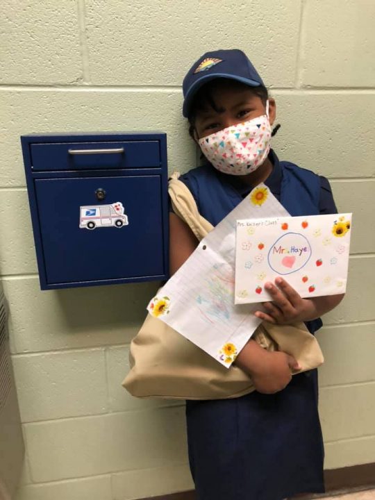 Julianna spreads cheer by delivering mail and sharing a smile.
