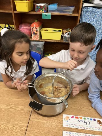 Students help prepare homemade applesauce.